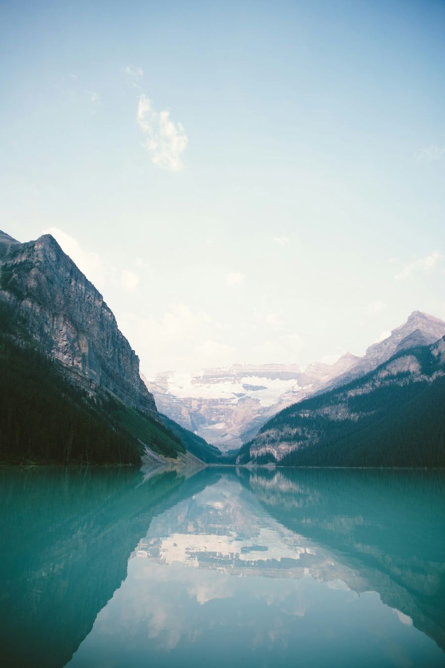 Still turquoise mountain lake reflecting glaciers